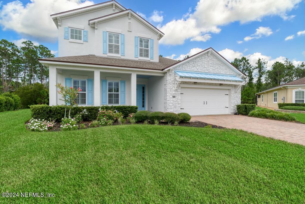 a front view of a house with a garden