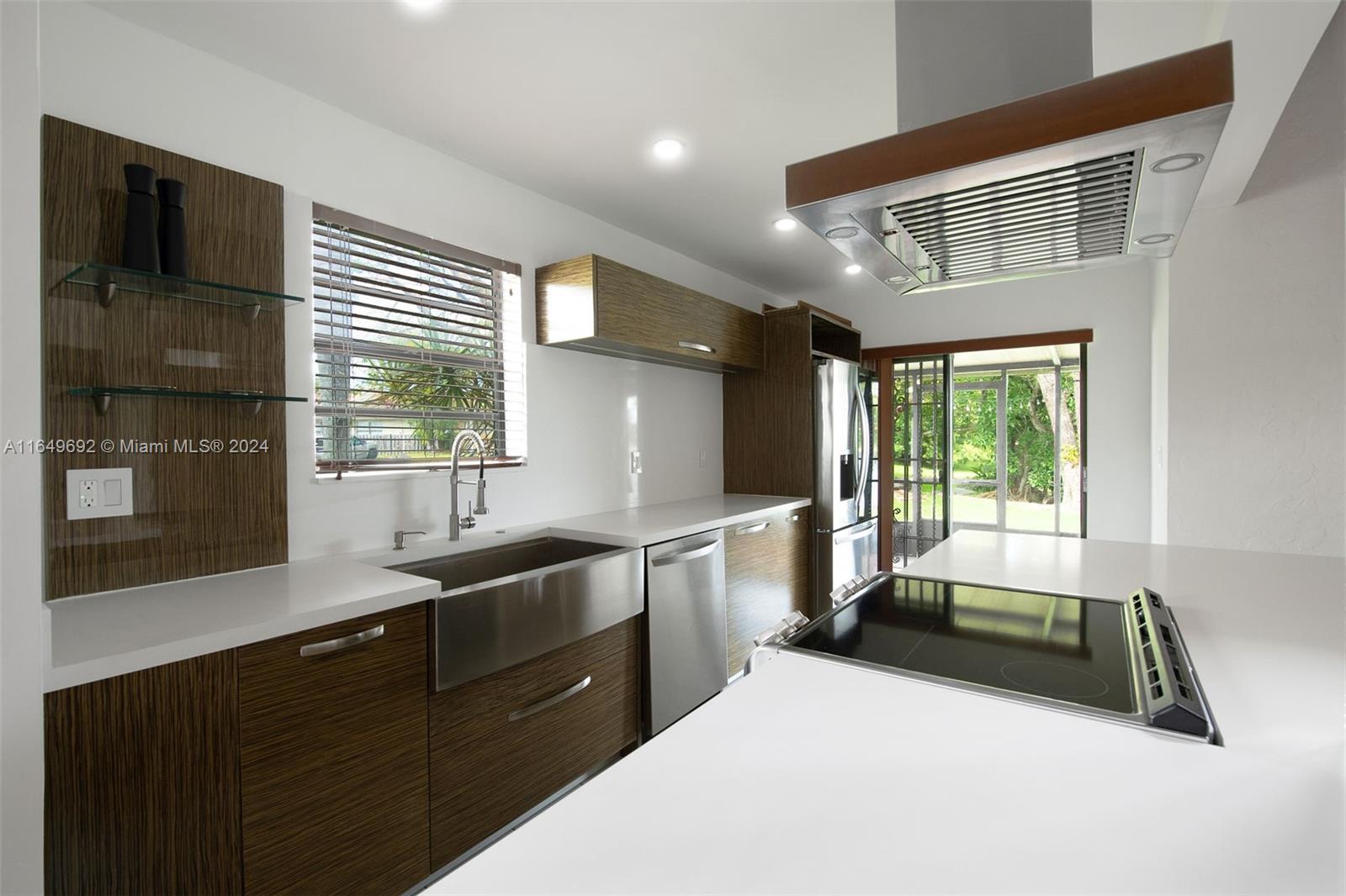 a kitchen with granite countertop a sink and a stove top oven