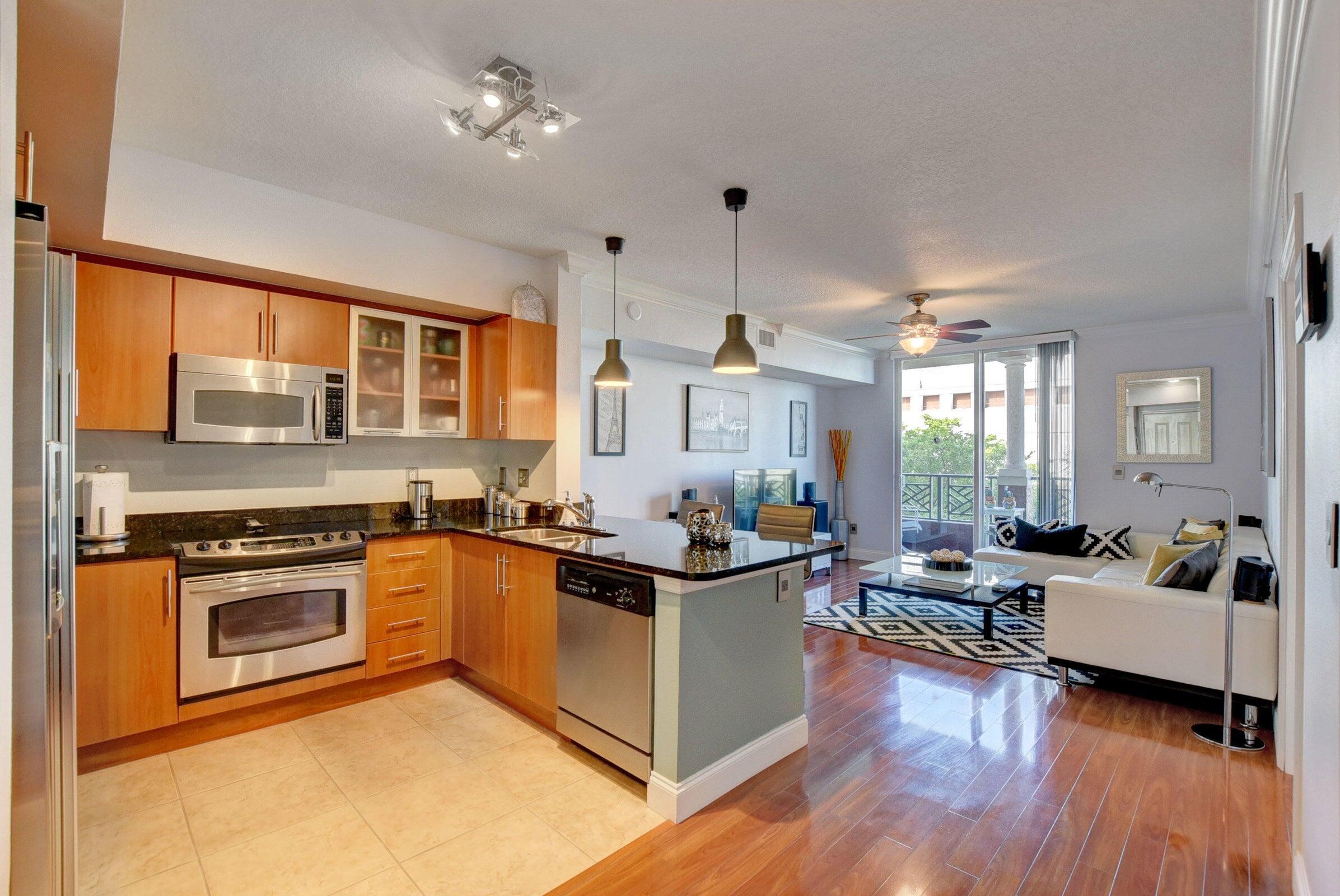 a view of a living room kitchen and a sink