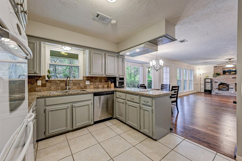 a kitchen with stainless steel appliances granite countertop a stove and cabinets