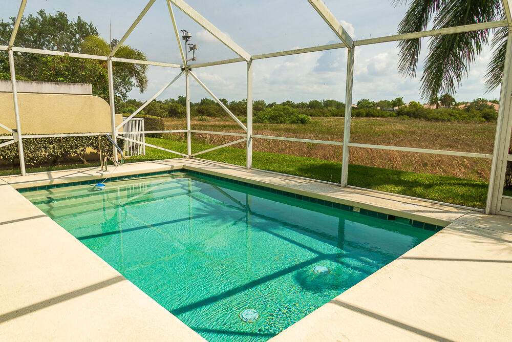 a view of a backyard with swimming pool