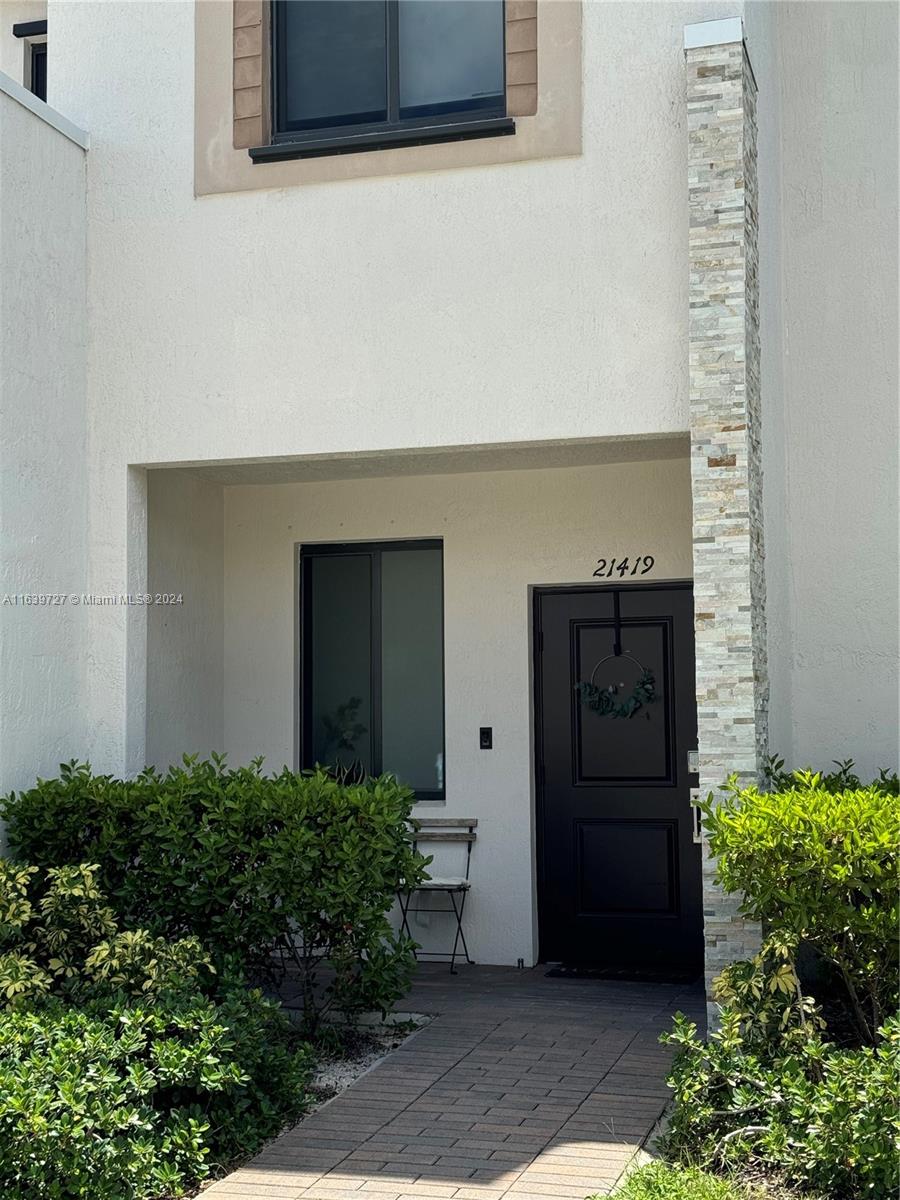 a couple of potted plants in front of door