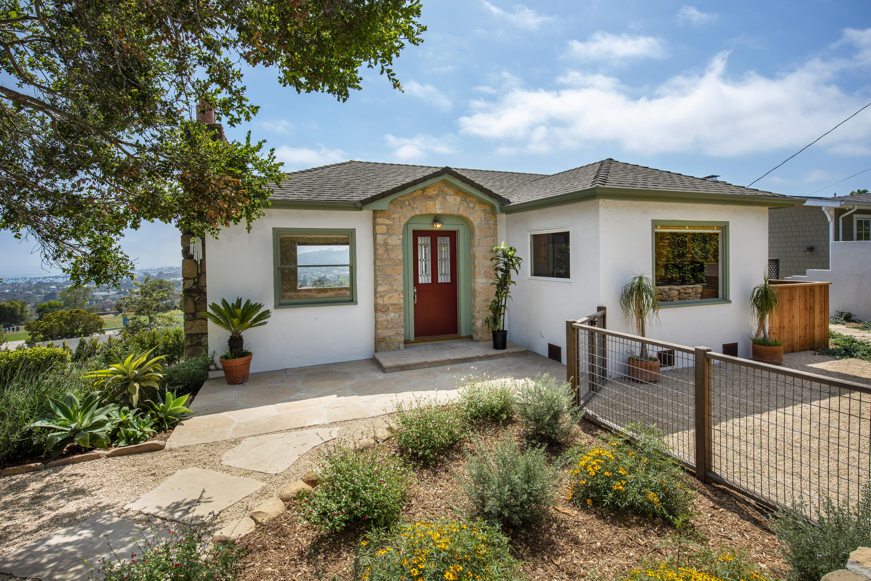 a view of a house with backyard and sitting area