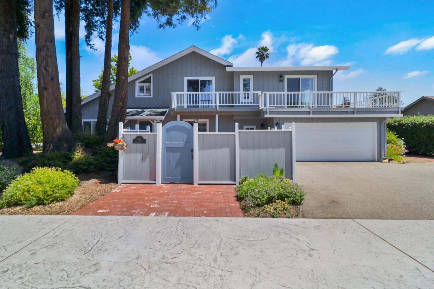 a front view of a house with a yard and a garage