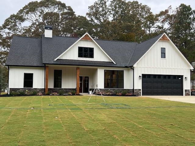 a front view of a house with yard and garage