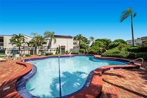 a view of a swimming pool with outdoor seating