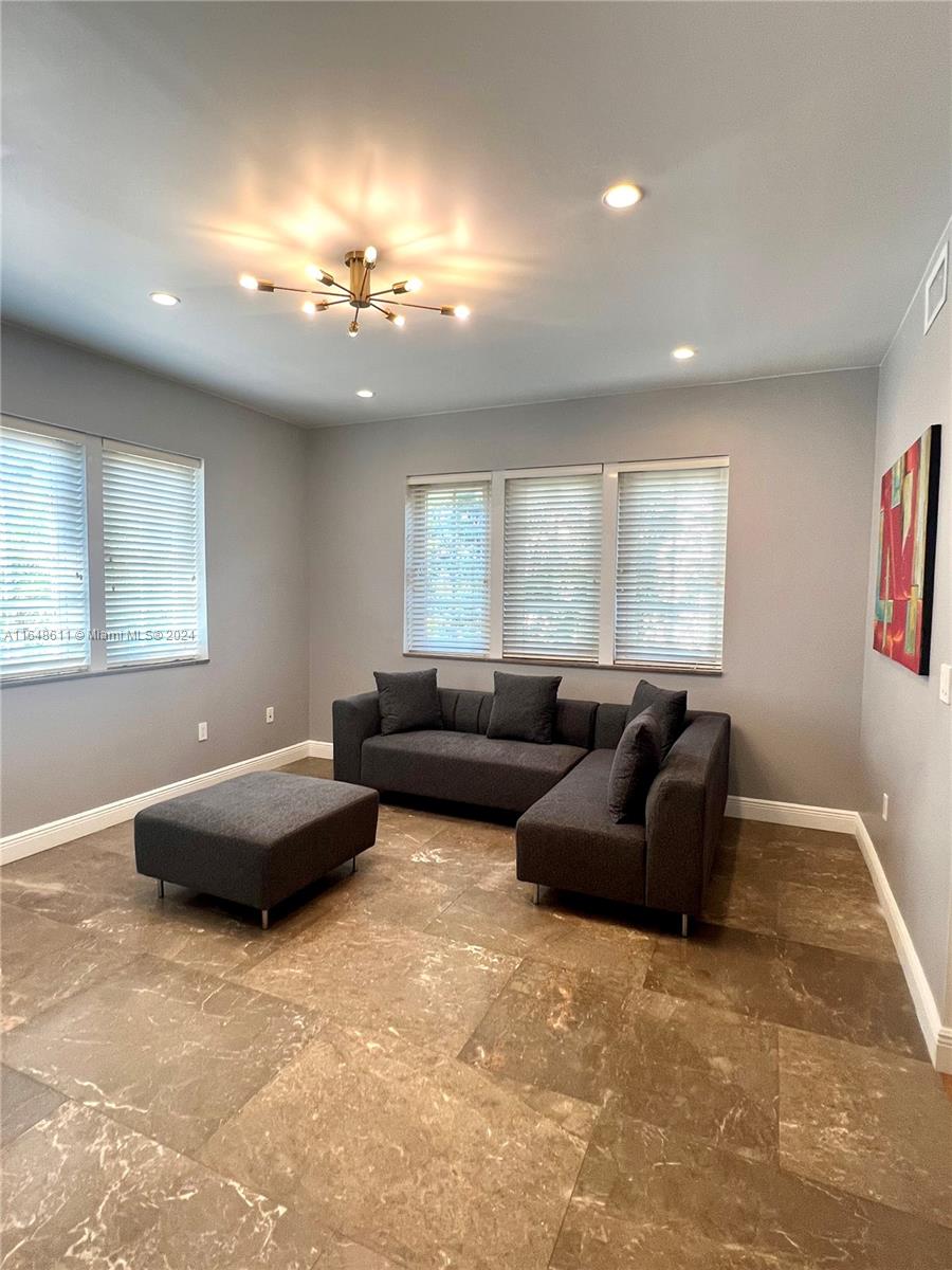 a living room with furniture and a chandelier