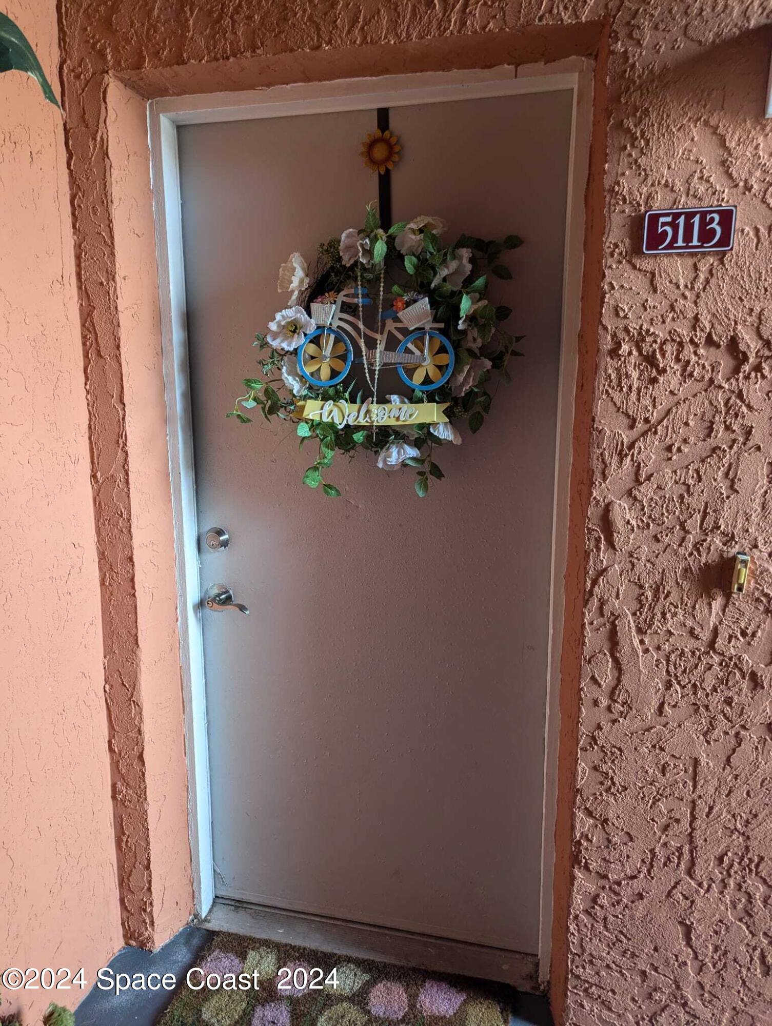 a vase with flowers sitting on a shelf