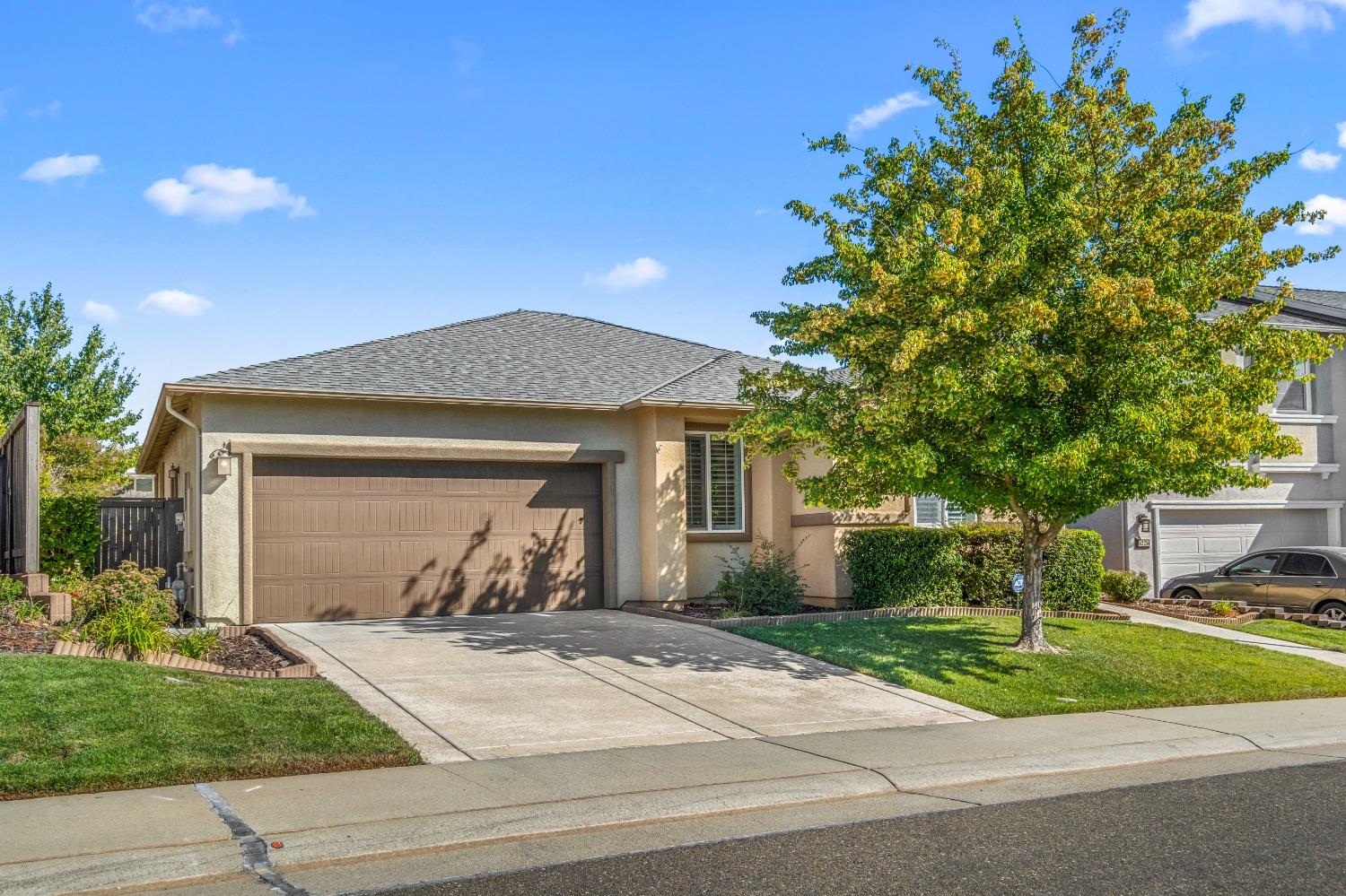 a front view of a house with a yard and a garage