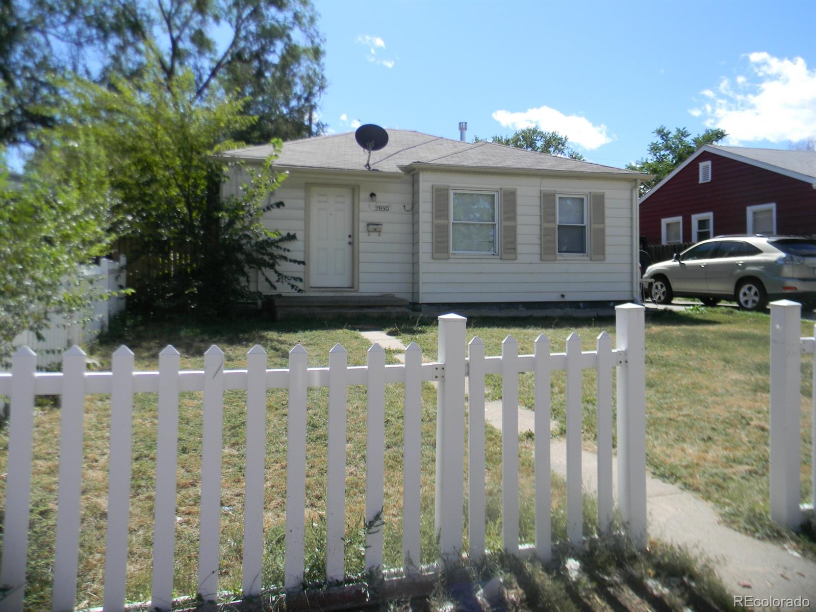 a view of a house with wooden fence