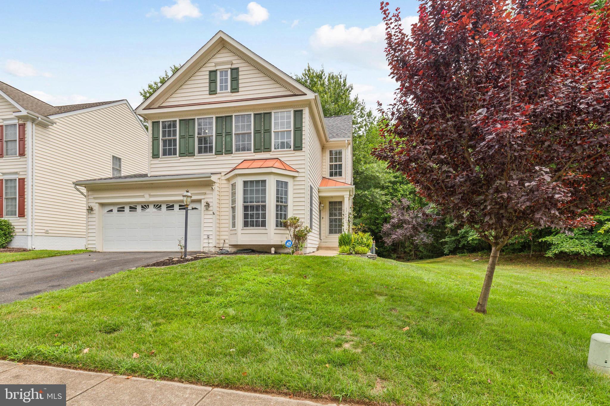 a view of a house with a yard and deck