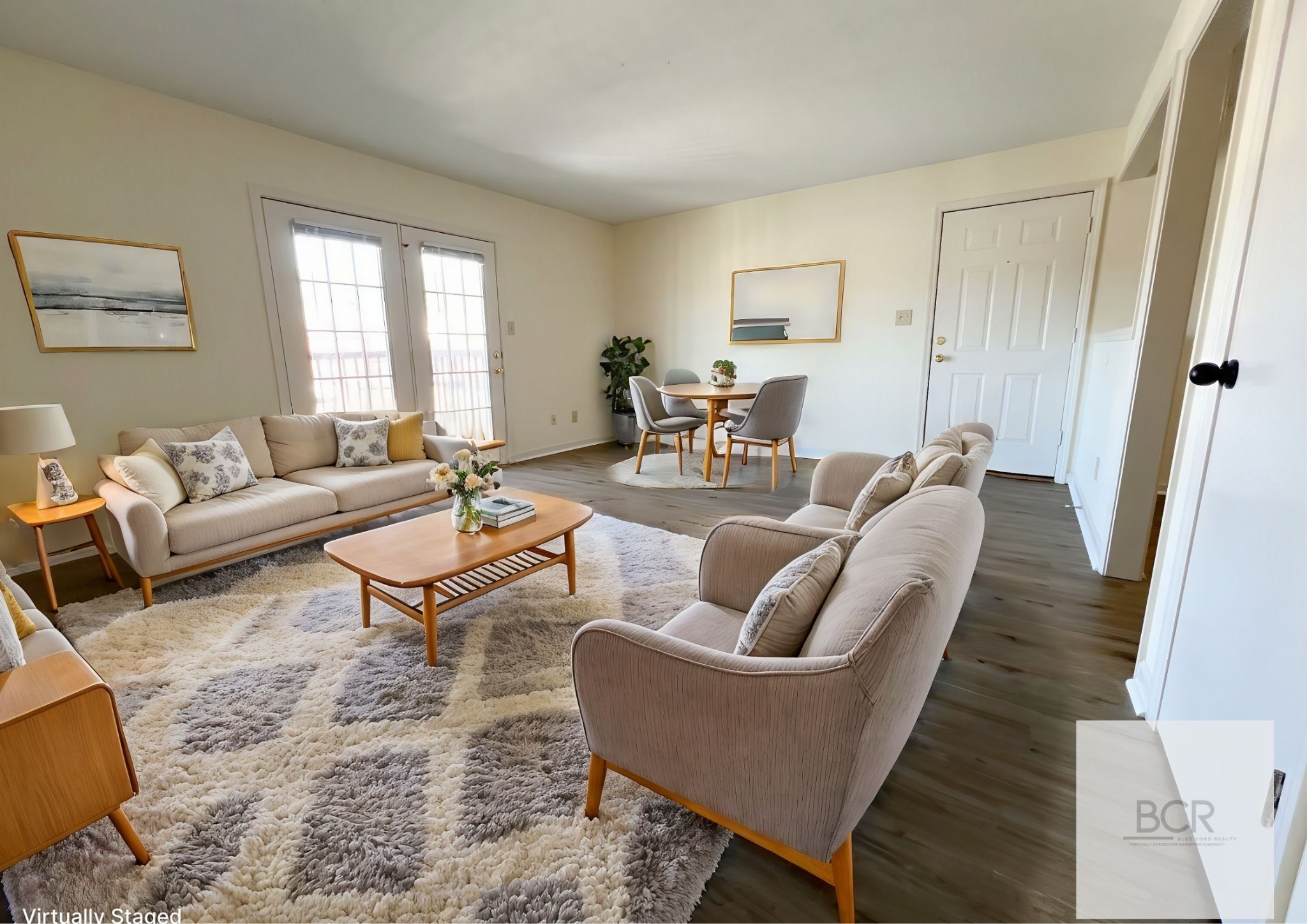 a living room with furniture wooden floor and a window