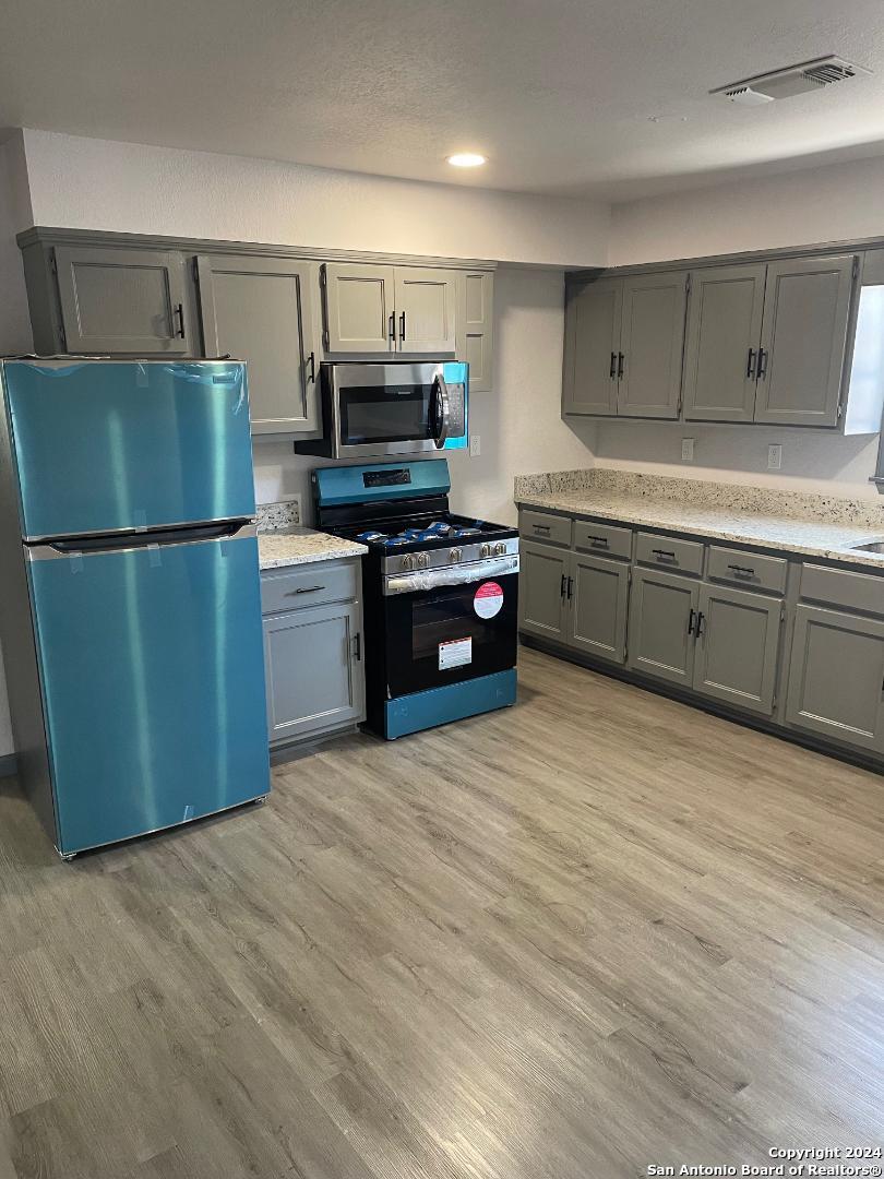 a kitchen with a refrigerator and a sink