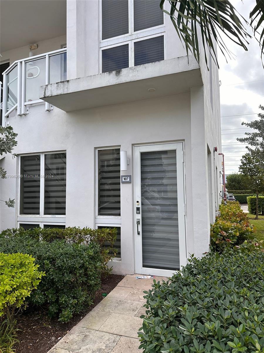 a front view of a house with plants