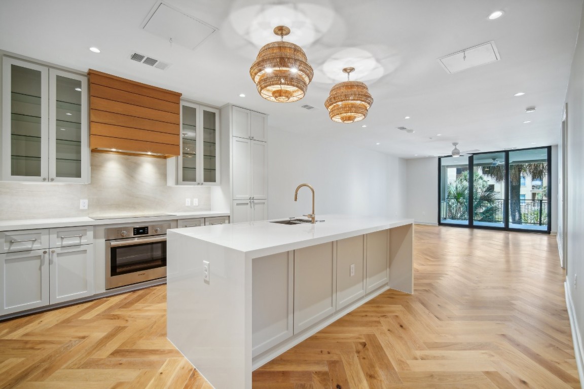 a kitchen with a sink stove and cabinets