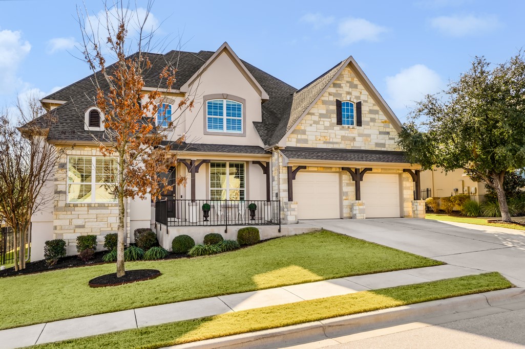 a front view of a house with a yard and garage