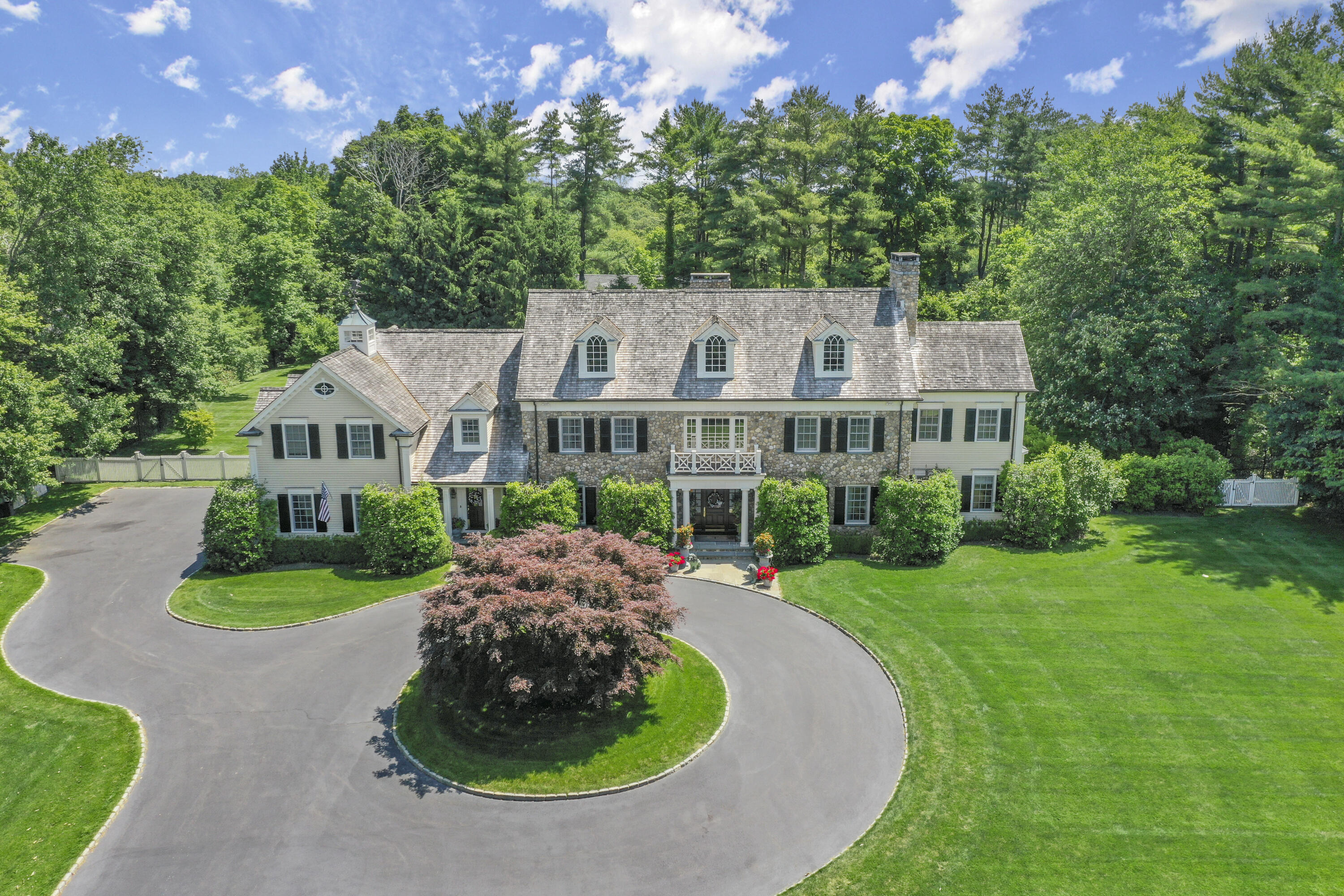 a aerial view of a house with yard and green space