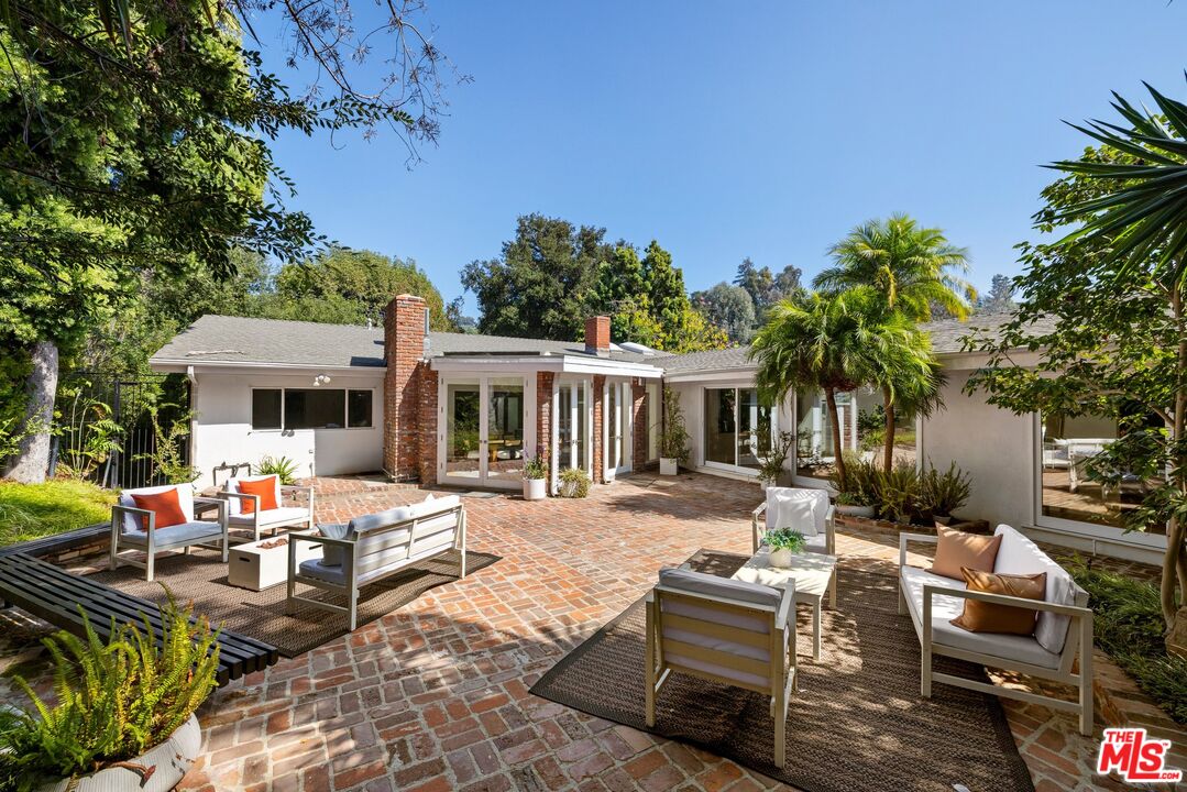 a view of a house with backyard sitting area