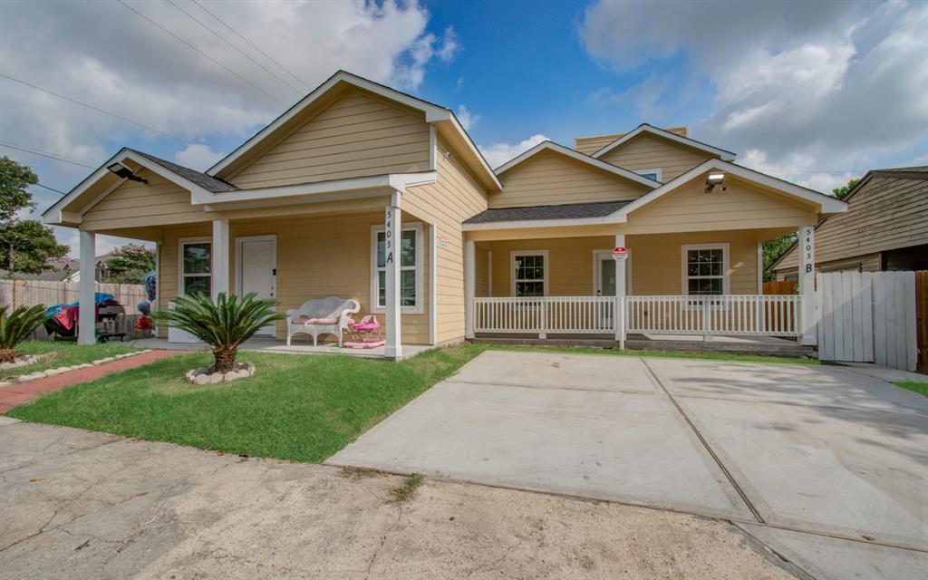 a front view of a house with a yard and a garage