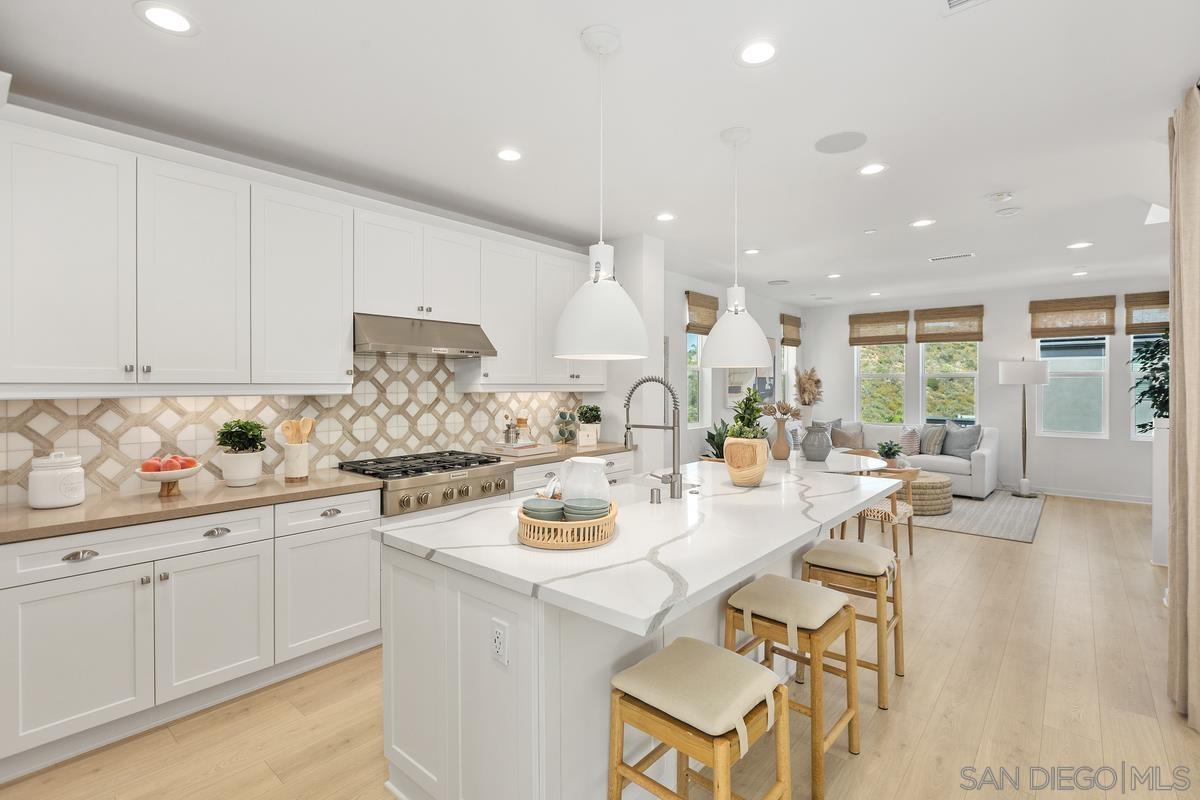 a kitchen with a sink white cabinets and white appliances