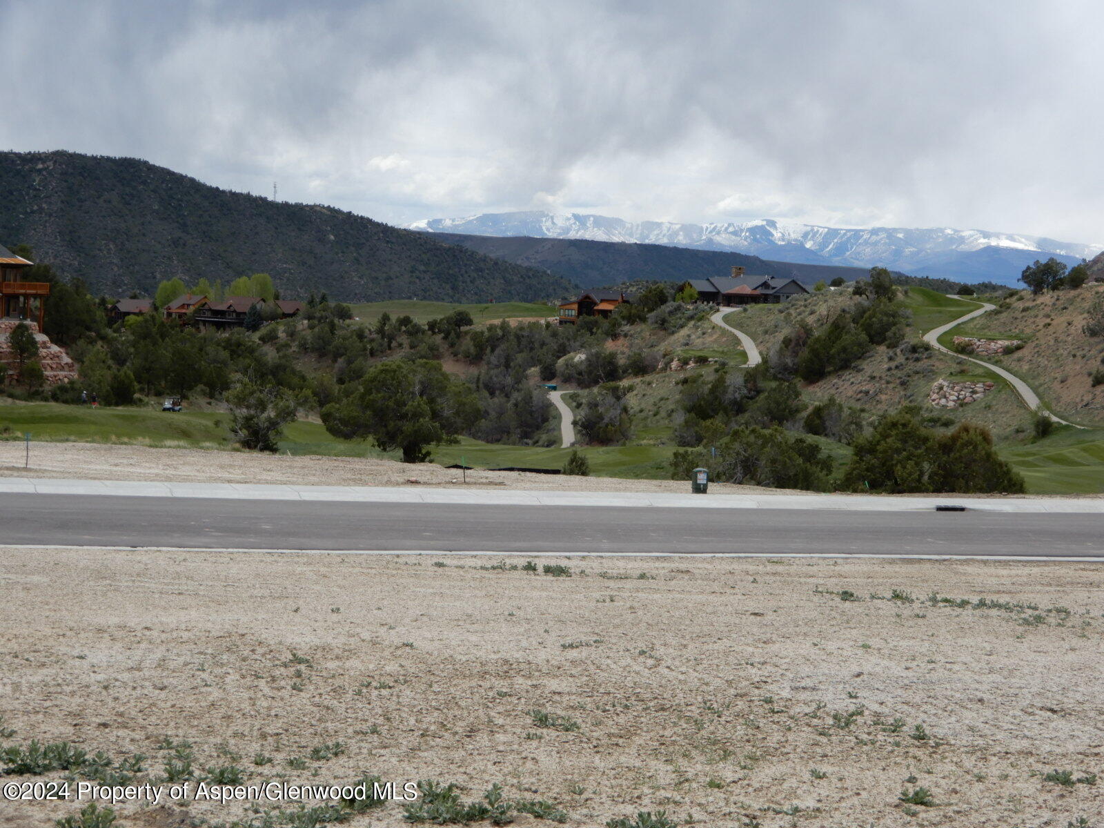 a view of a dry yard with mountain