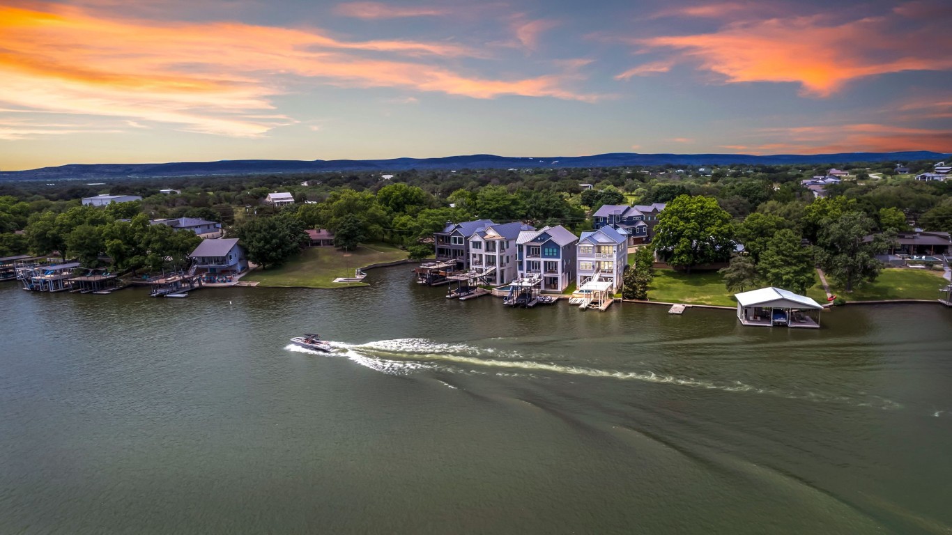 an aerial view of residential houses with lake view