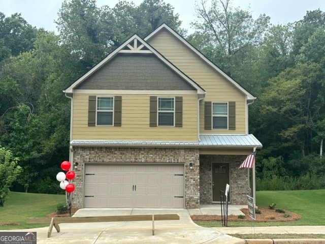 a front view of a house with a garden