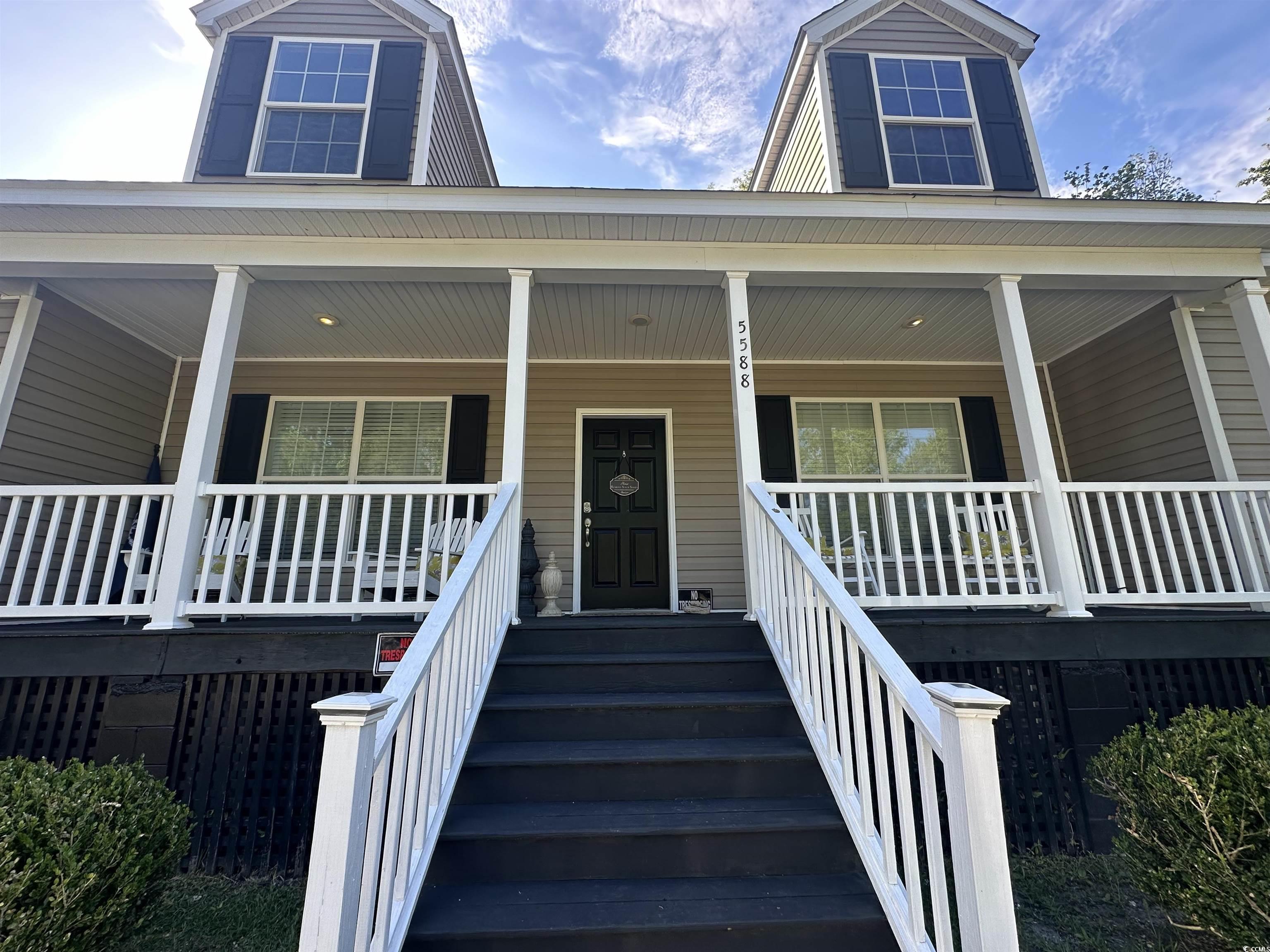 Entrance to property featuring covered porch