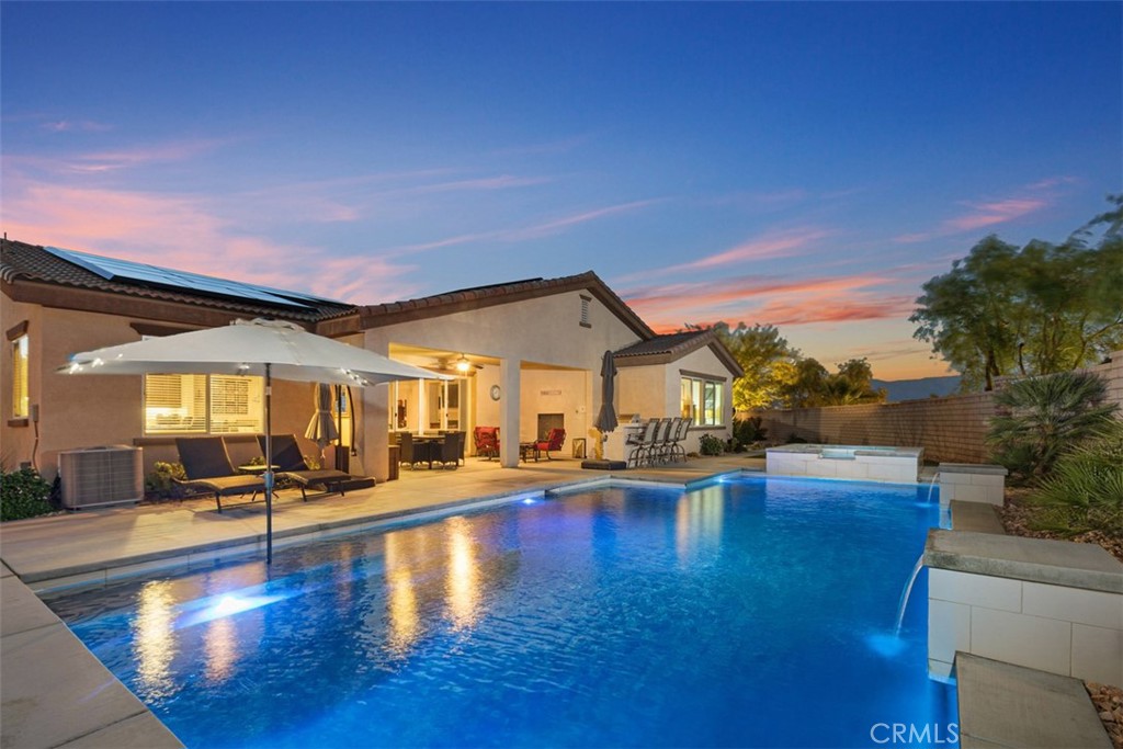 a view of a swimming pool with outdoor seating