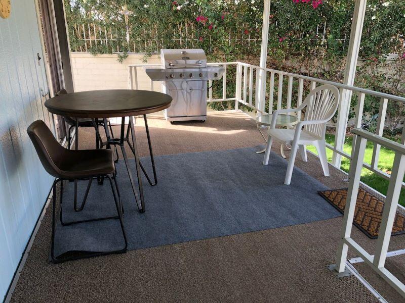 a view of balcony with wooden floor and outdoor seating