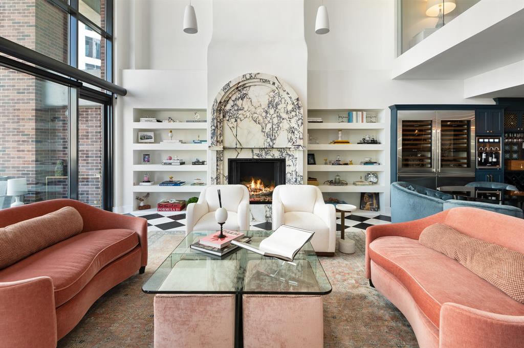 a living room with furniture a fireplace and a chandelier