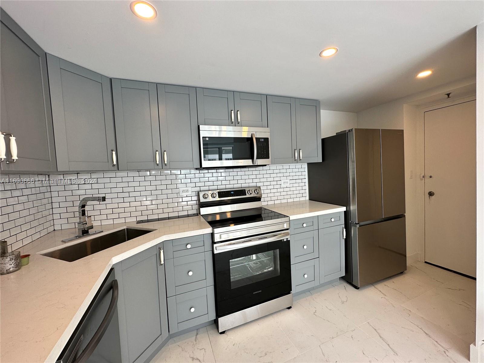 a kitchen with a sink stove and refrigerator