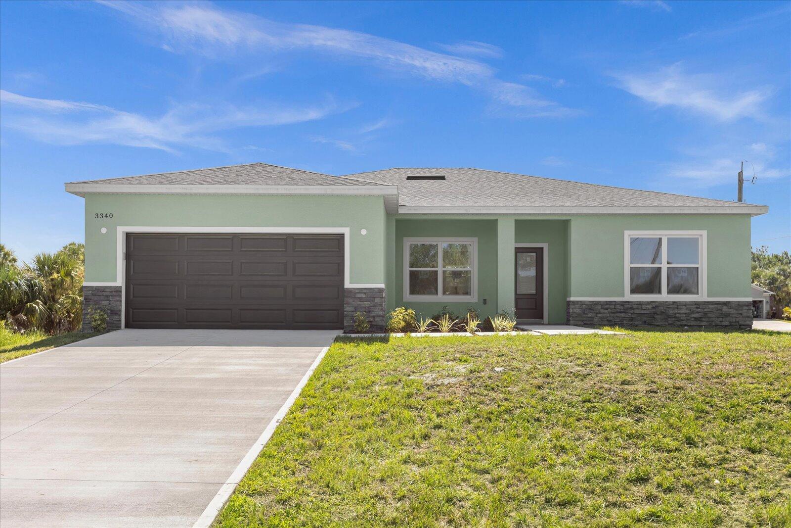 a front view of a house with a garden and yard