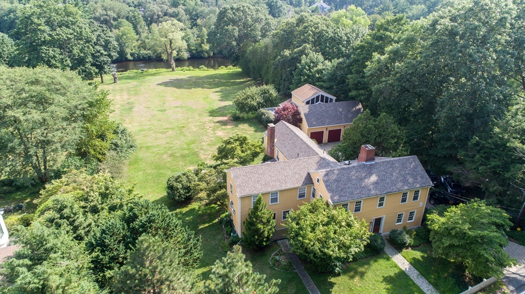 an aerial view of house with yard and swimming pool