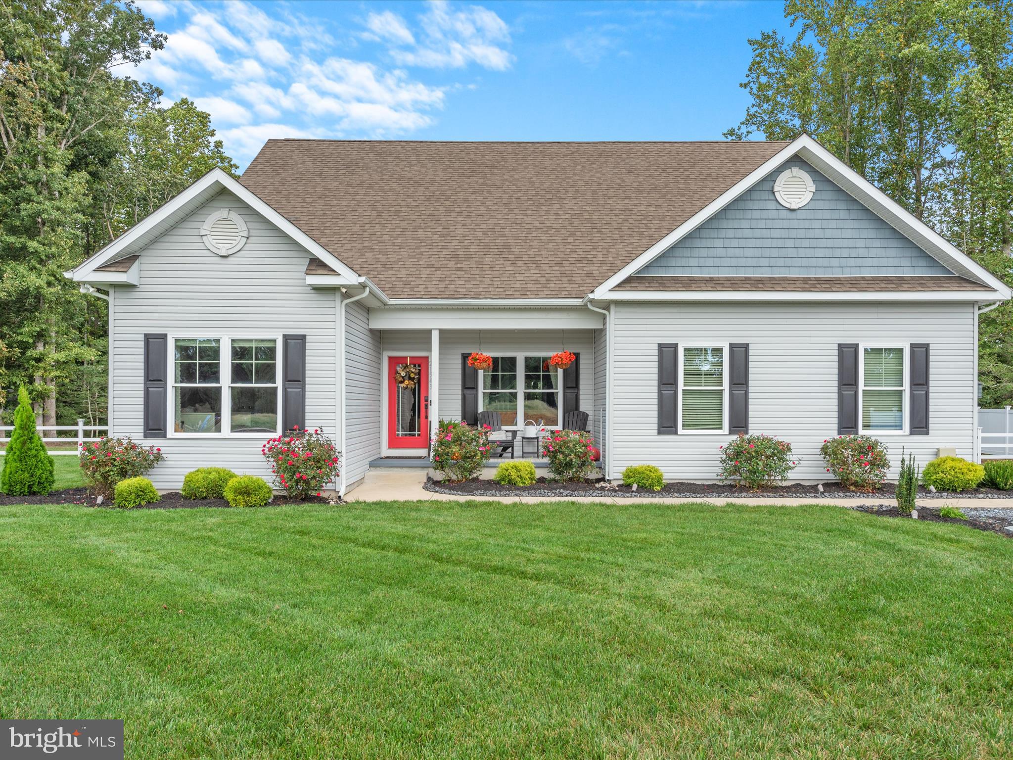 a front view of house with yard and green space