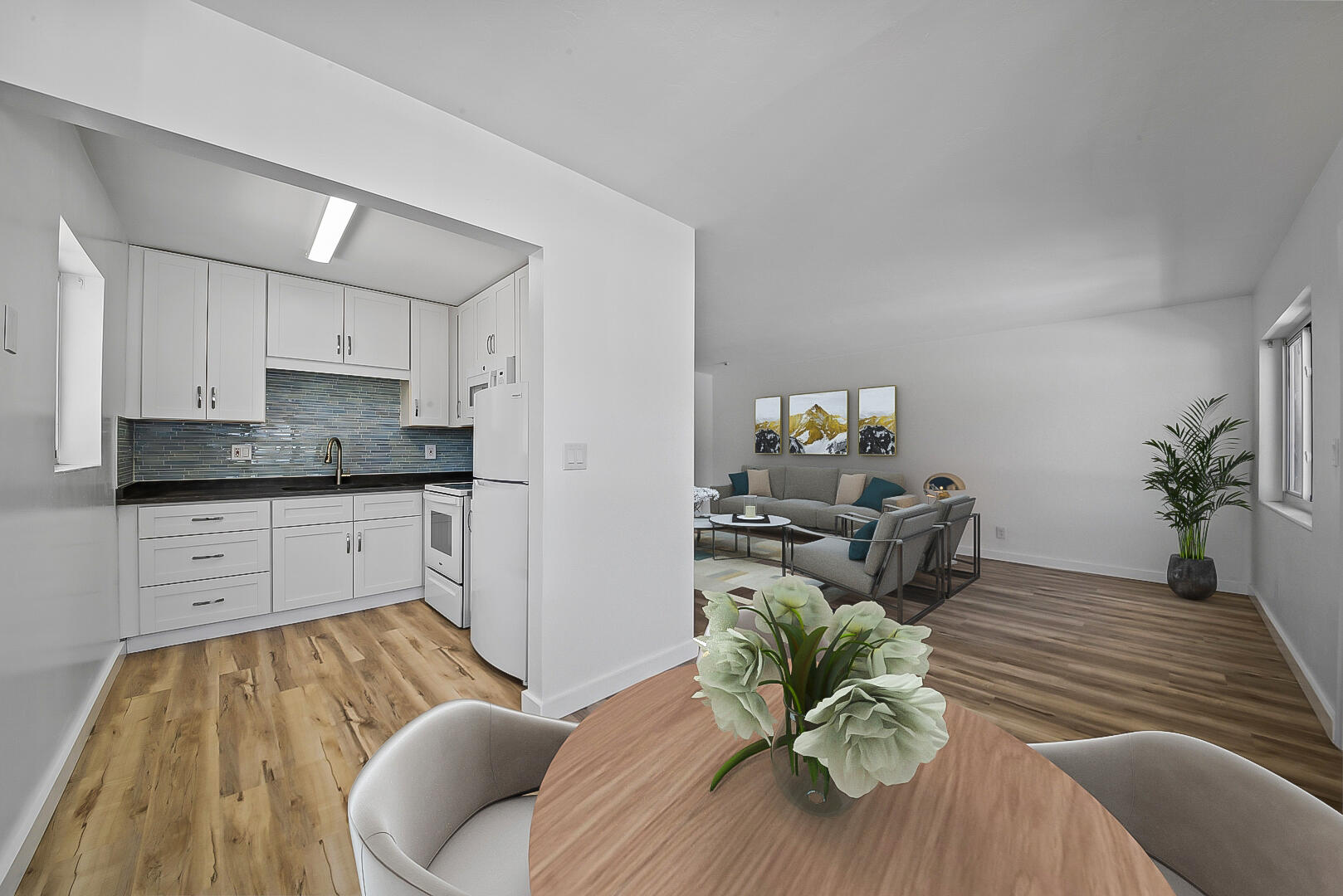 a living room with kitchen island furniture and a chandelier