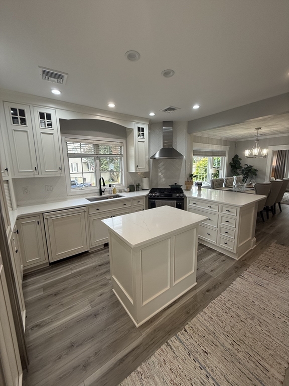 a large white kitchen with a stove a sink dishwasher and a refrigerator