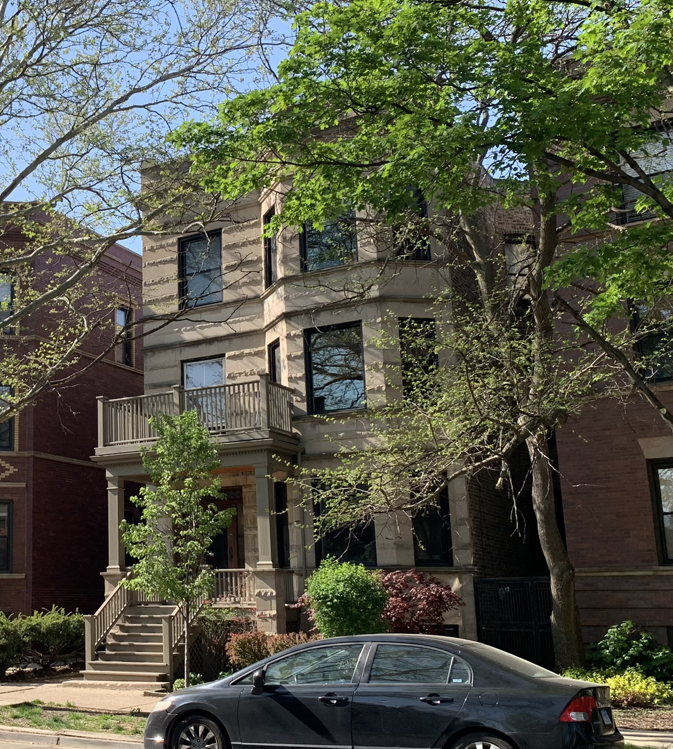 a front view of a house with plants