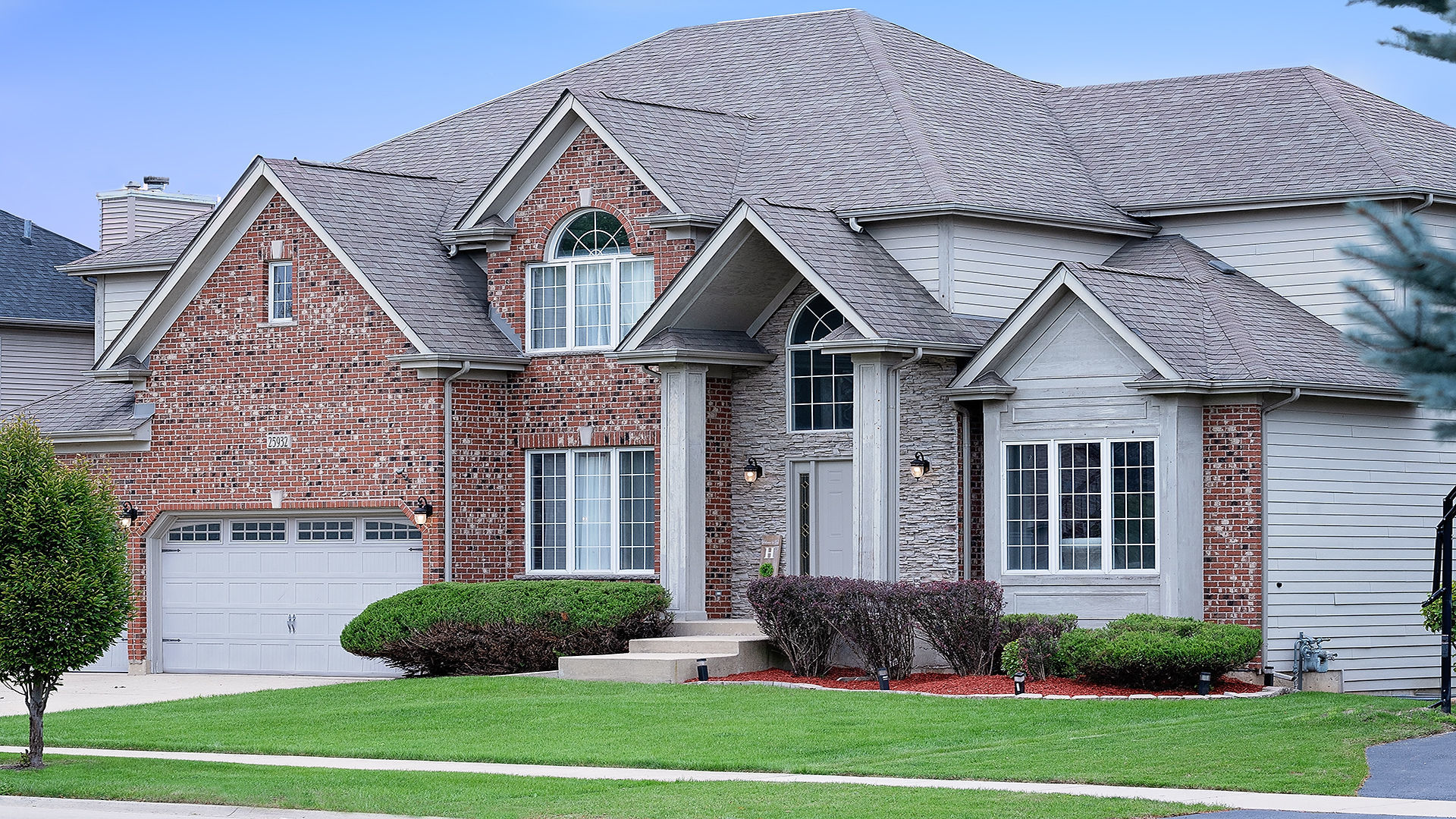 a front view of a house with a yard