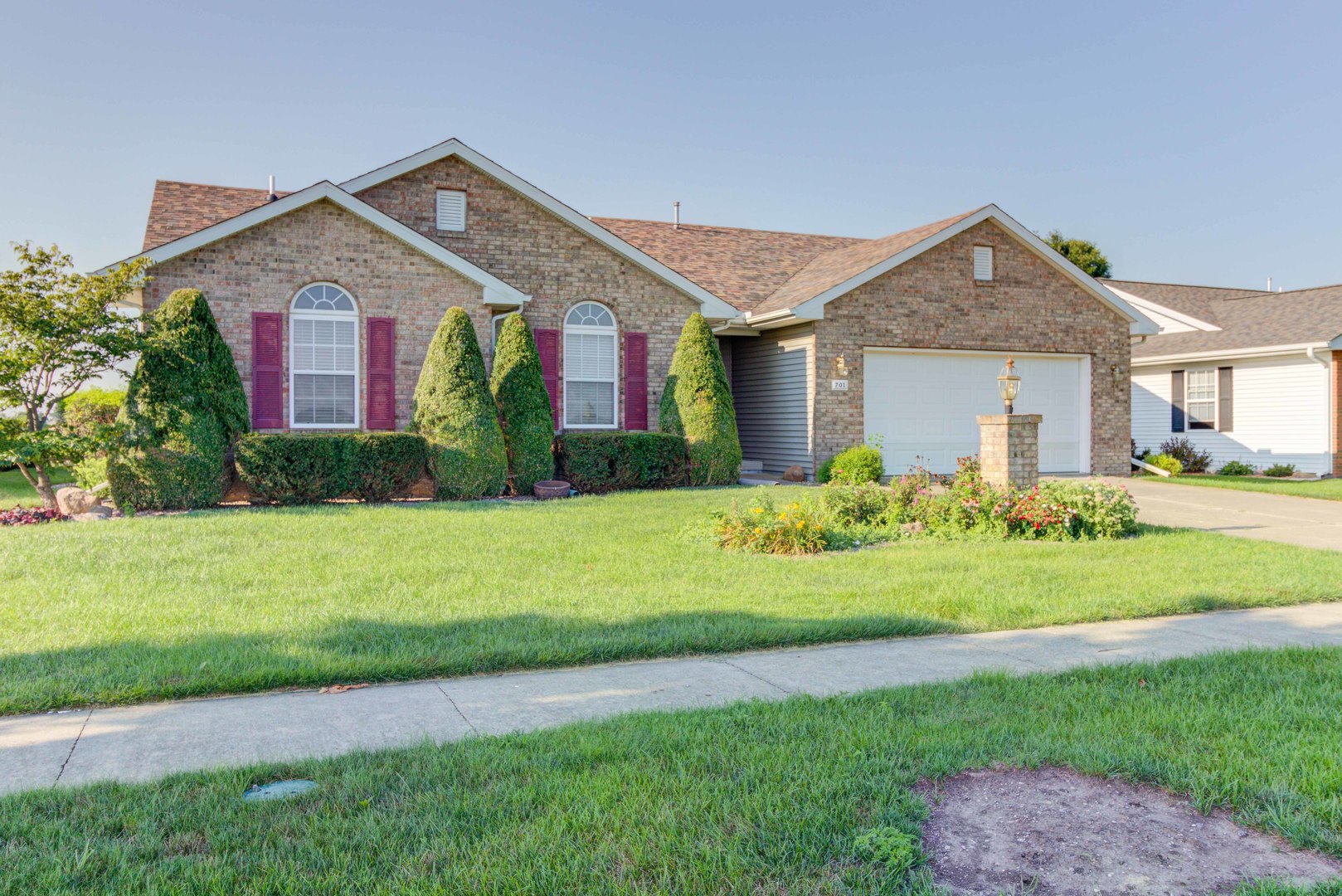 a front view of house with yard and green space