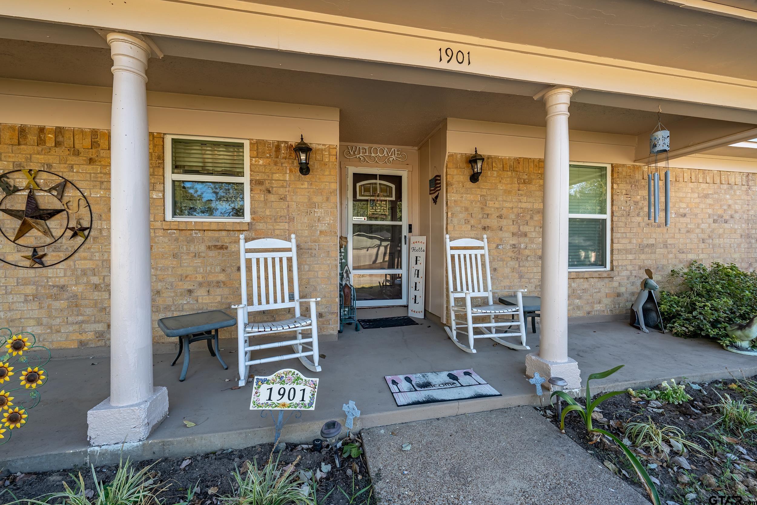 front view of a house with a bench