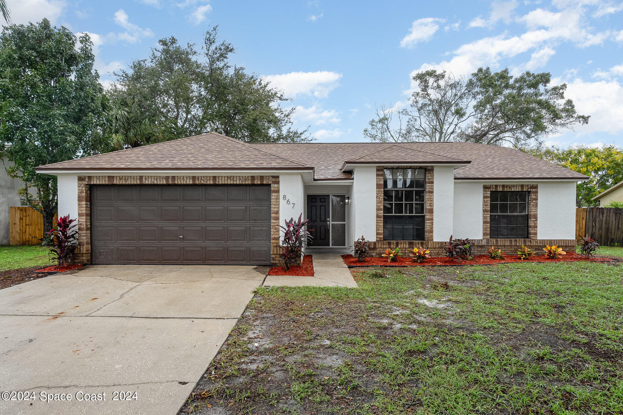 front view of a house with patio and a yard