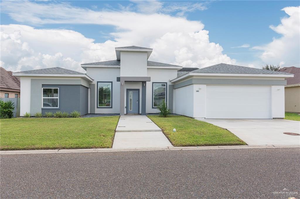 a front view of a house with a yard and garage