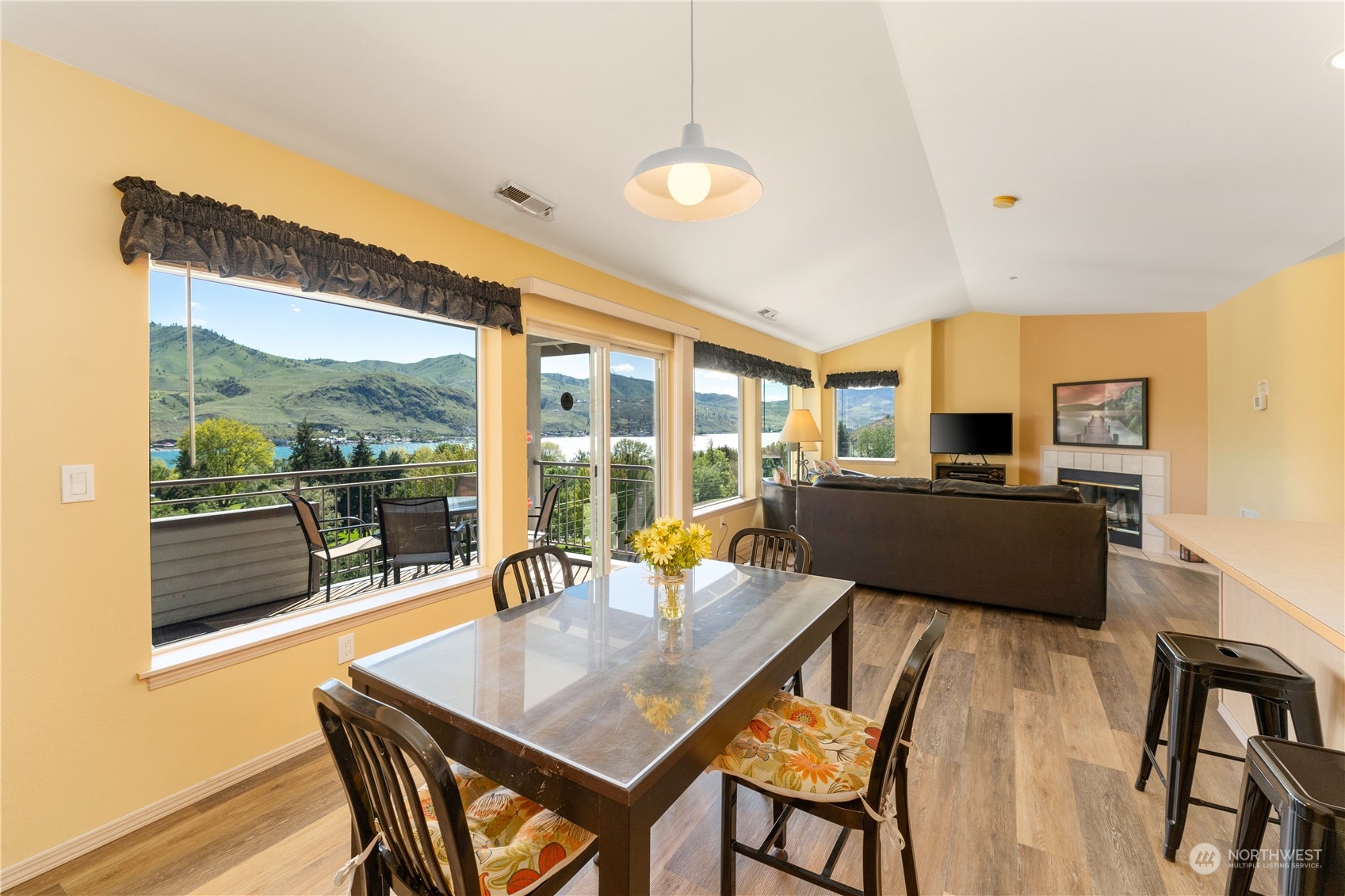 a living room with furniture and a floor to ceiling window