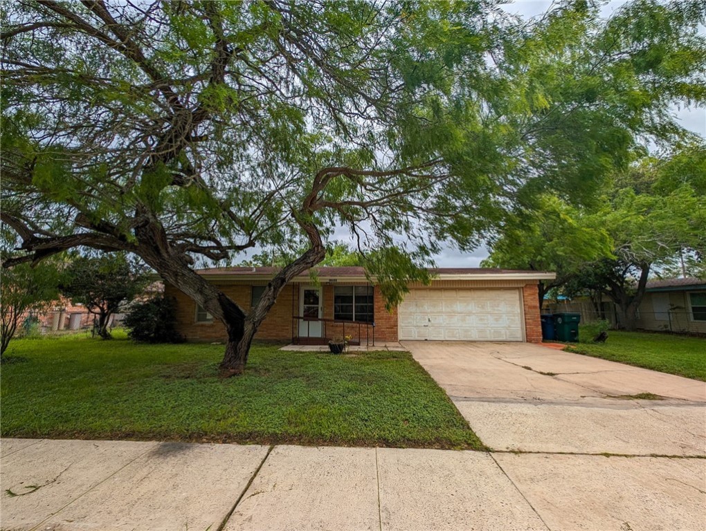 a front view of a house with a garden and trees