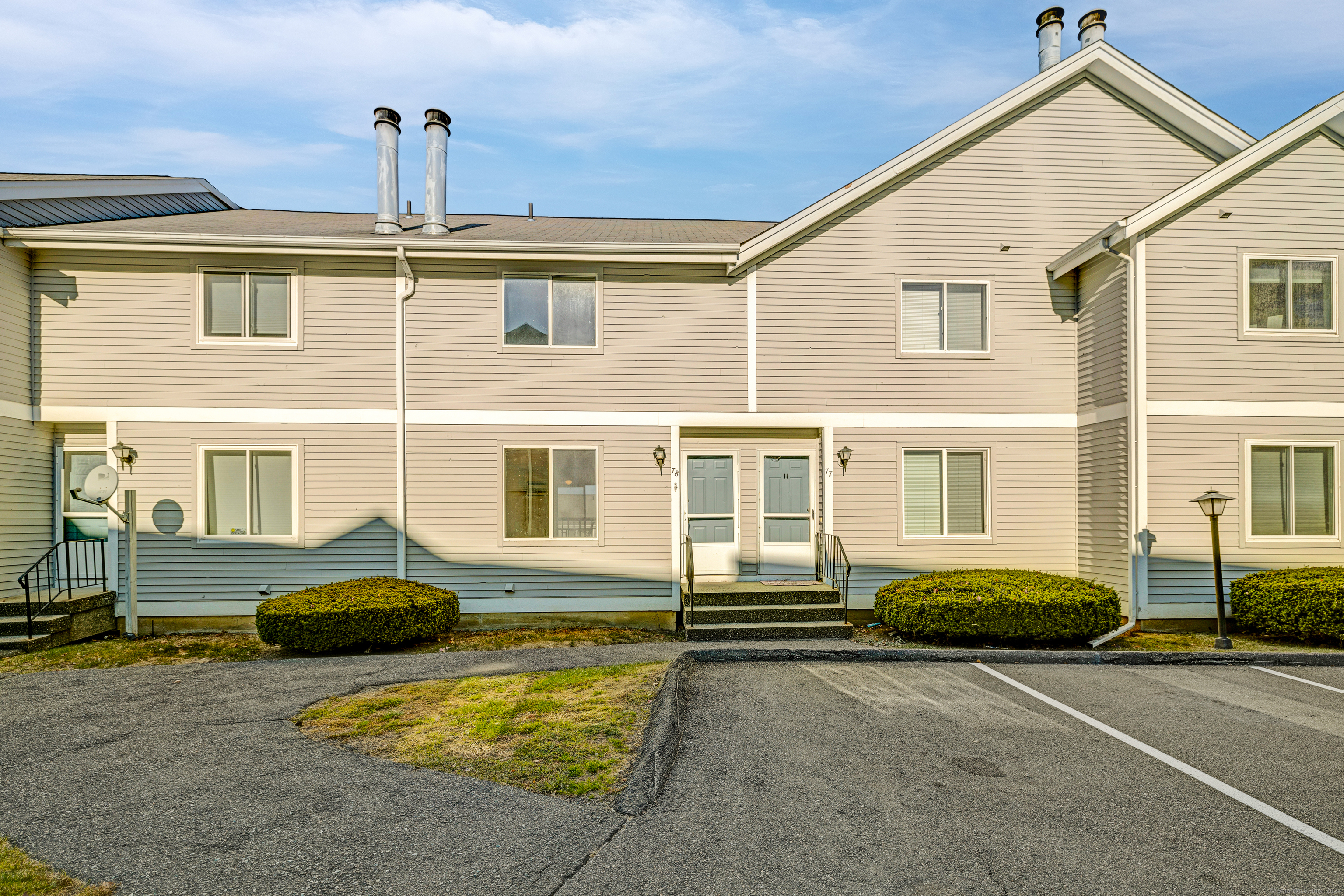 a front view of a house with car parked