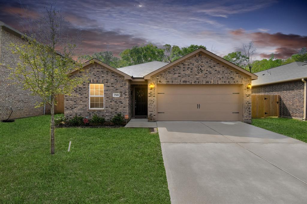 a front view of a house with a yard and garage