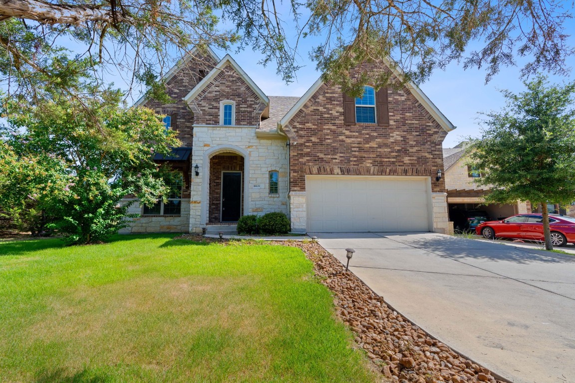 a front view of a house with a yard and garage