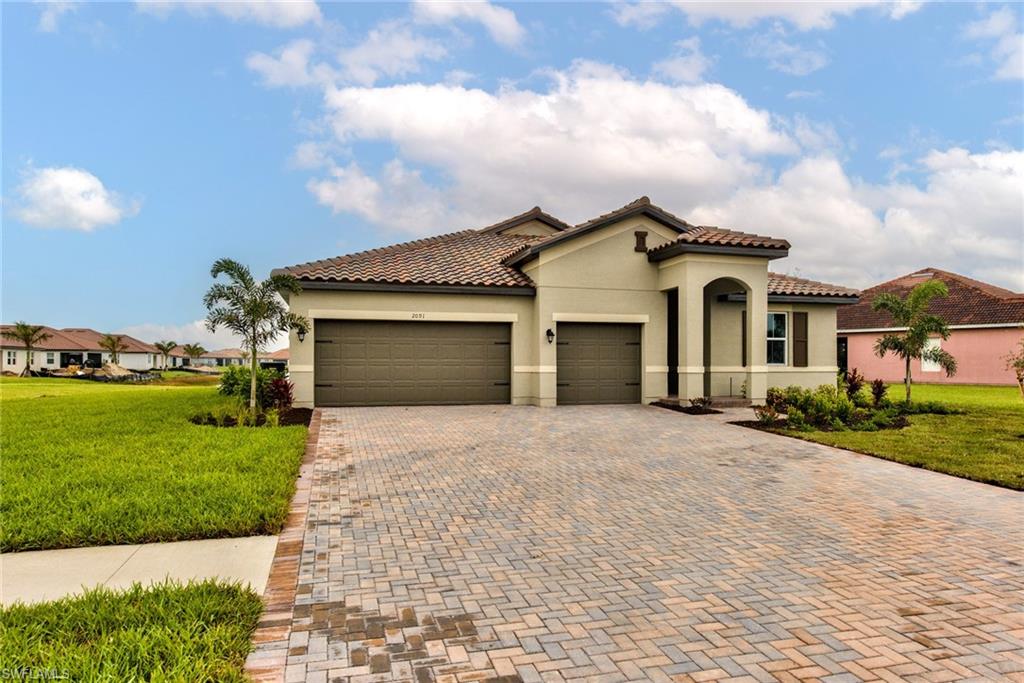 a front view of a house with a yard and garage