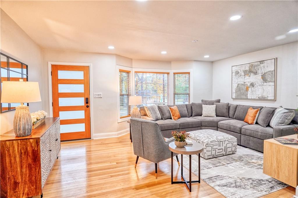 a living room with furniture and wooden floor